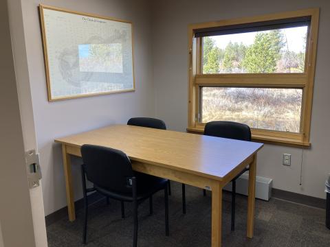 Small room with a rectangular table and 3 chairs.