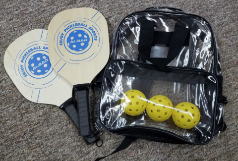 A pickleball set including two rackets, three yellow balls, and a bag.