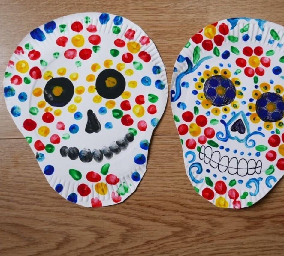 Two painted paper plate skulls for Dia de los Muertos.